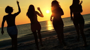 stock-footage-group-carefree-boy-girl-teenagers-casual-beachwear-enjoying-beach-party-at-sunset-on-vacation